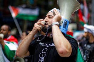 Hash Tayeh leads the chant in Melbourne.