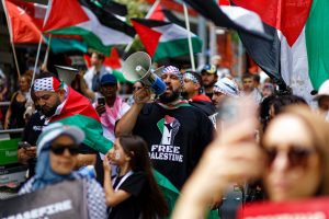 Man leads the chant in Melbourne.