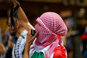 Woman leading the chant at the Gaza protest, Melbourne.