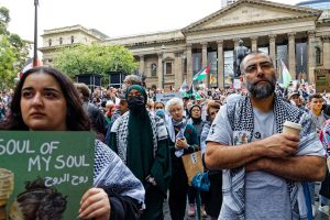 Listening to speeches at a ceasefire now rally State Library, Melbourne.