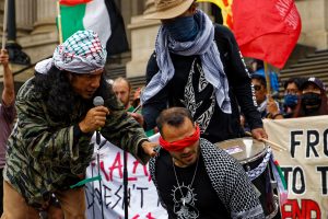 Performance during a ceasefire now rally out the front of Parliament House, Melbourne.