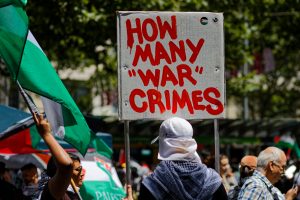 Flags and banners proliferate as people arrive for the Gaza ceasefire rally in Melbourne.