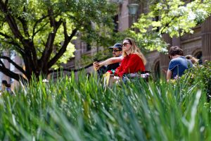 People sitting in the shade at the State Library waiting for the Palestine rally to start, Melbourne