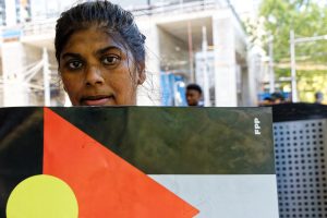 Indigenous Australian woman supporting Palestinians.