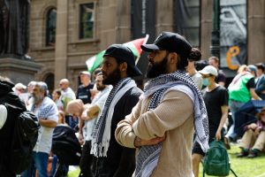 Men waiting for the rally to begin.