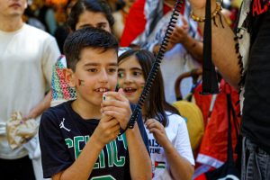 Young boy leads the chant.