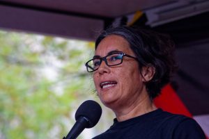 Celeste Liddle addresses the crowd gathering to march in solidarity with Palestinians.