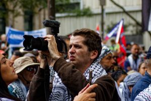 Matt Hrkac recording the speeches at Melbourne's ceasefire now rally.