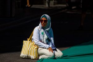 Woman waiting for the #CeasefireNow rally to start, Naarm (Melbourne).